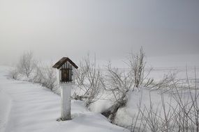 Icon in small house in snow field
