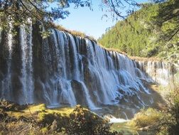 nuoerliang waterfall in forest, china, jiuzhaigou