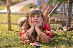 blonde girl in indian clothes on grass