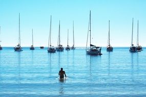 man at sea with yachts