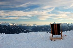 chair stands on snow at scenic mountain landscape, austria, innsbruck