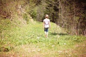 Girl is walking on the meadow