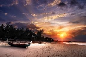 landscape of boat on sand beach at the sunset