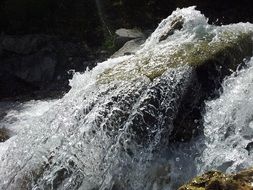 Landscape of waterfall on Italy mountains in the sun close-up