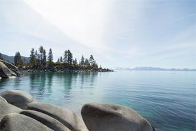 stones near the water on a background of mountain nature