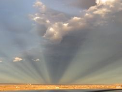 photo of fan sun rays of the sun on the horizon