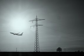 aircraft on takeoff and high-voltage tower