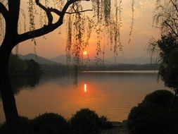 landscape with peaceful sunset on the lake