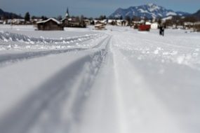 ski trails on glossy snow at mountain village