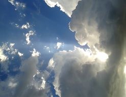 rays of light through white fluffy clouds