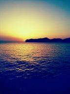 sunset on the ocean horizon with calm water