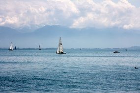 sailing boats on calm constance lake at scenic mountains