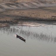 fishing boat on a sandy beach background