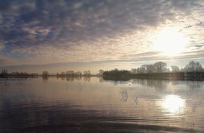 reflexion of morning sky on calm lake at winter