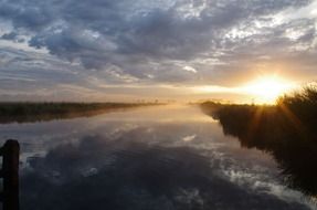 sunrise over a canal in holland