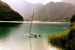 boat on the green water of the lake