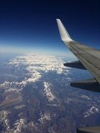 plane wing above mountains