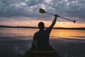 paddler in a boat at sunset