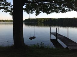 swing and pier on the lake