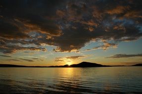beautiful landscape of mirroring blue lake at the sunset