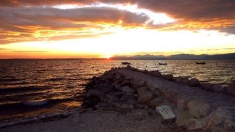 sunset in the clouds on the horizon above the water