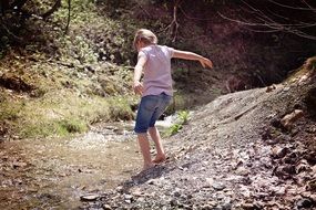 littlegirl barefoot near stream