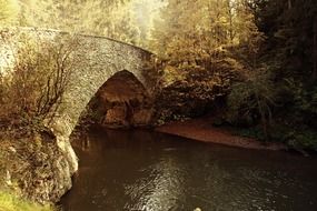 Photo of the bridge over the river in autumn