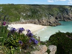 white sand beach near the rocks