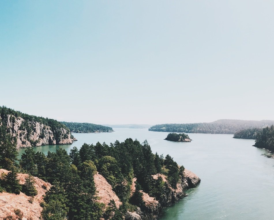 forested rocks at lake, calm landscape