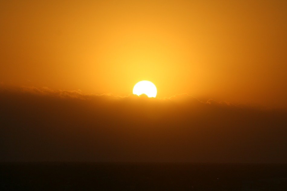 the sun in the sky at sunset