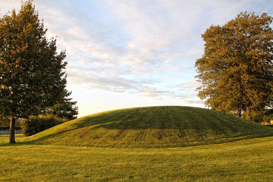 summer landscape with trees besides of burial mound