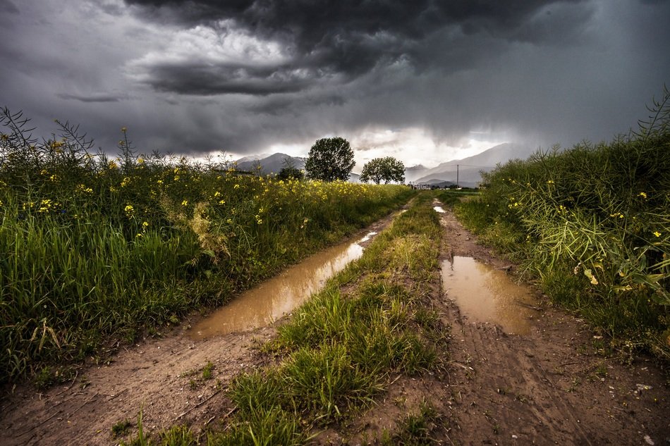 country unpaved road in stormy weather