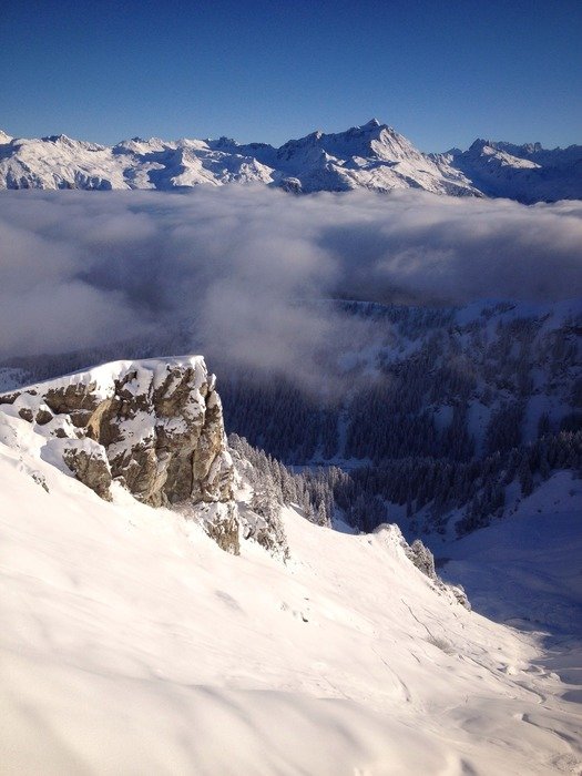 a top of mountains covered with snow