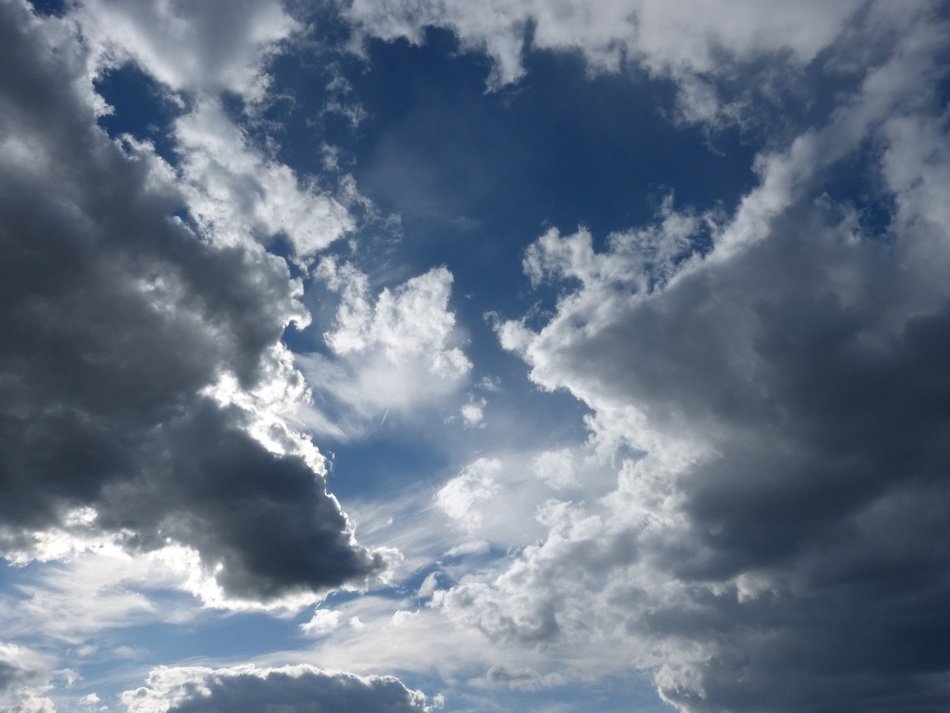 glimpses of the sun through the cloudy sky