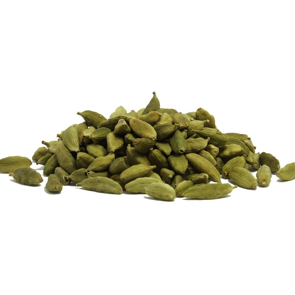a pile of aromatic cardamon pods on a white background