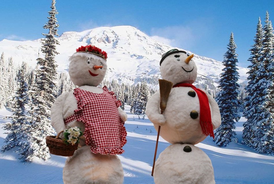 Beautiful white snowmen with colorful clothes in the picturesque mountains