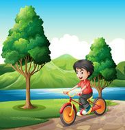 boy biking at the riverbank