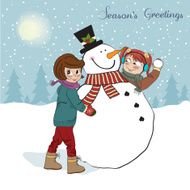 two happy girls building a snowman N5