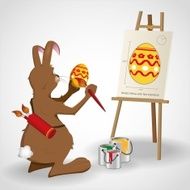 Easter bunny rabbit decorating an egg with paint