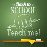 Pencil in the fist on chalkboard with back to school