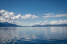mirror image of clouds in a blue lake