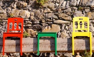 three colorful wooden chairs