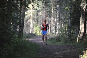 man runner on a forest path in Finland