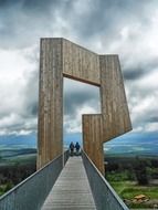 Couple on art sculpture on a background of cloudy sky