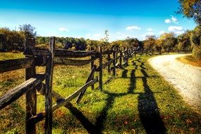 country road along a wooden fence