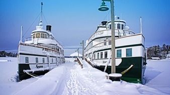 two ships in the harbor amidst the ice in Ontario, Canada