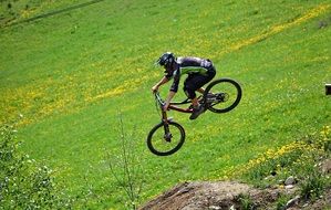 Cyclist in a jump among nature