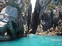 turquoise shiny water among high cliffs