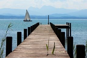 lake boardwalk with sailing vessel