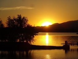 Sunset over the hill near the lake